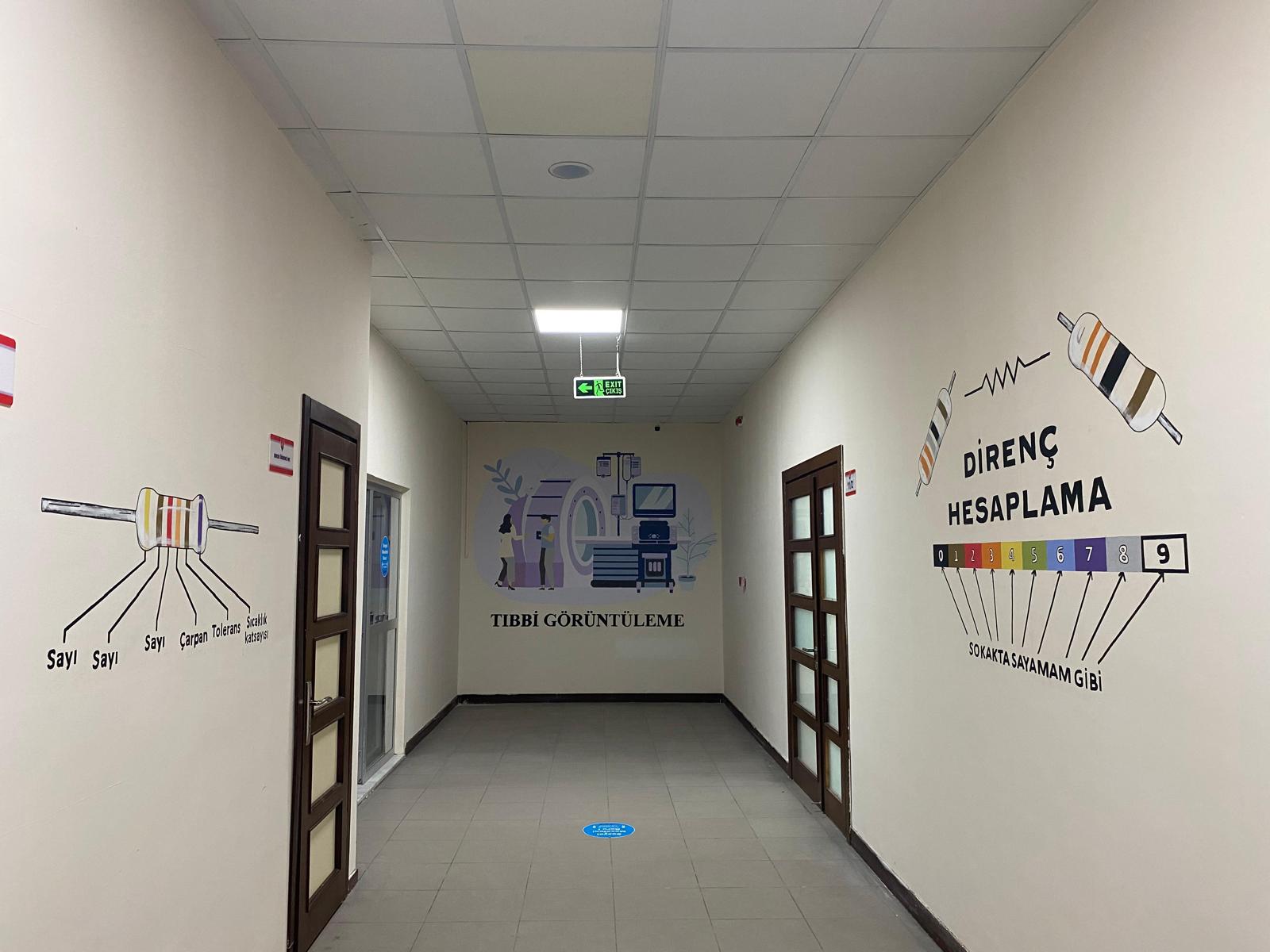 Tıbbi görüntüleme temalı duvar çizimleriyle atölye koridoru